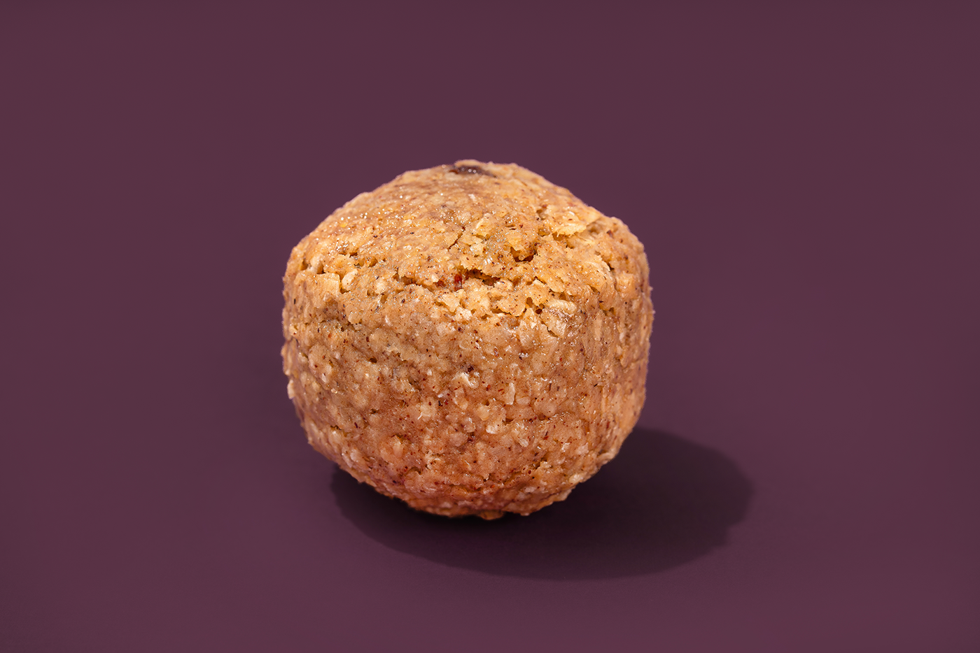 Probites Oatmeal Raisin — single bite on muted purple