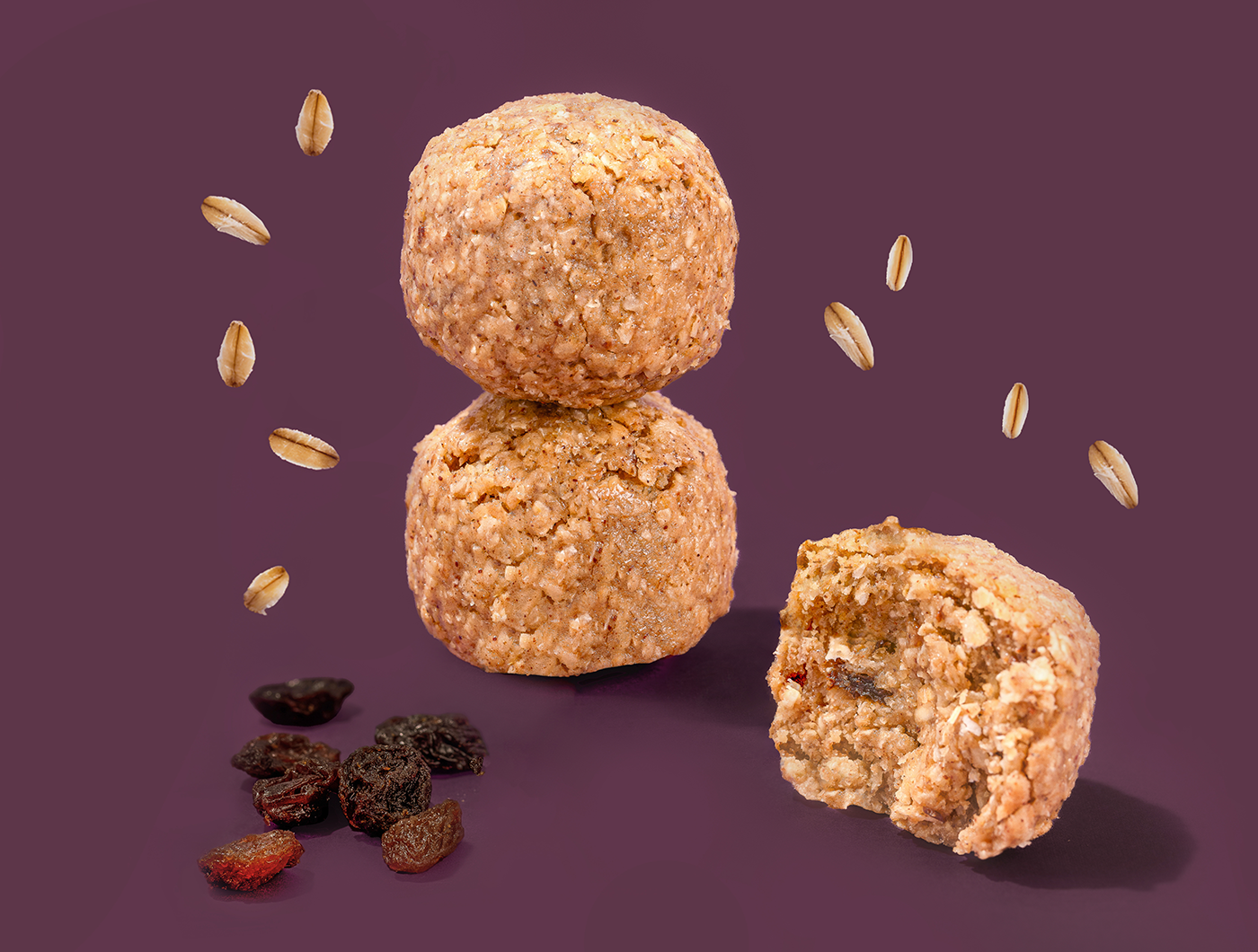 Probites Oatmeal Raisin — stacked bites with falling oats and raisins