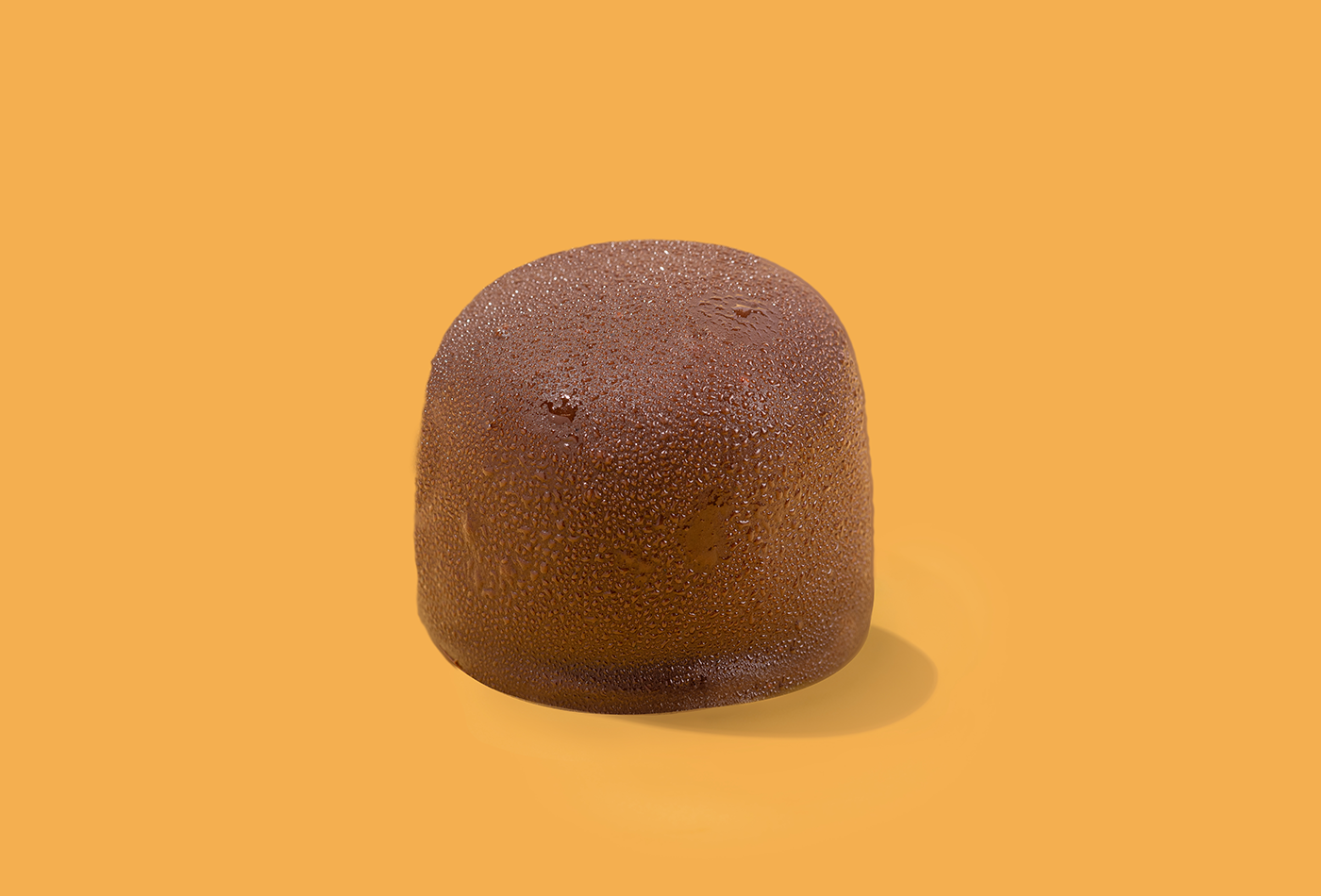 Probites Peanut Butter Coconut — single bite on warm orange
