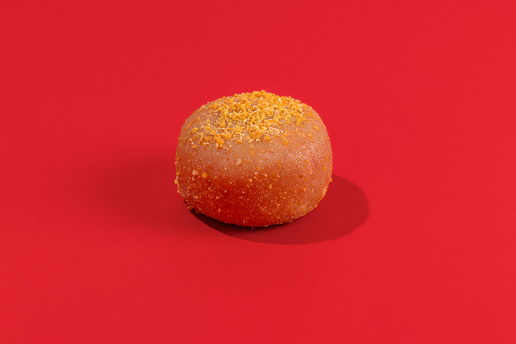 Probites Strawberry Cheesecake — single bite on red