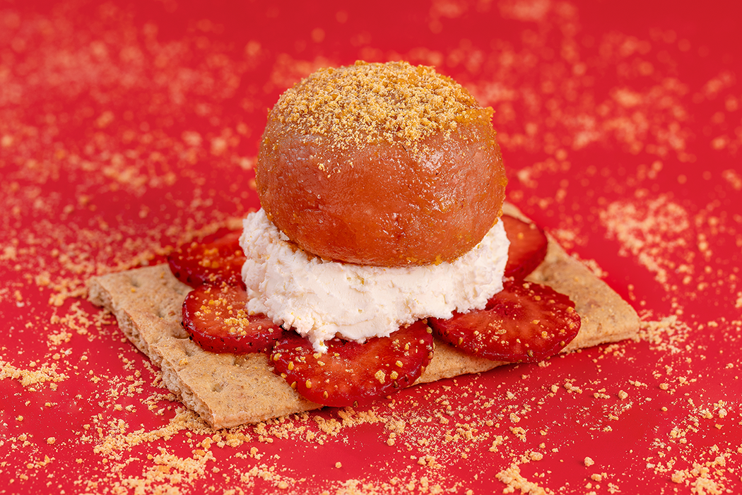 Probites Strawberry Cheesecake — styled with strawberries and cream